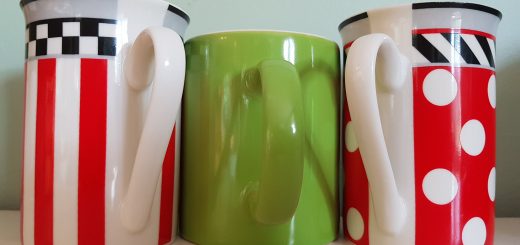 three mugs, red and white, green in the middle